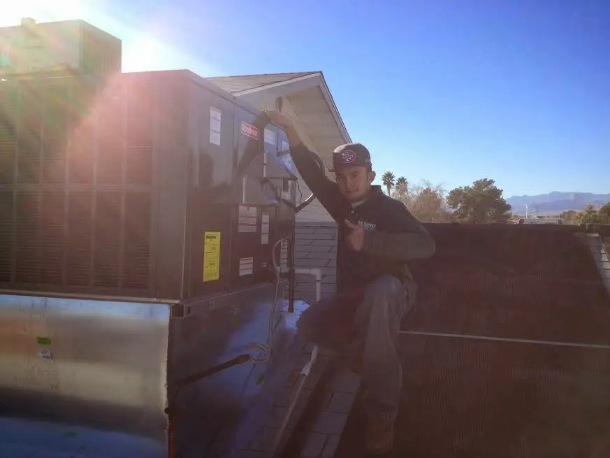 HVAC technician performing HVAC Inspection on a rooftop unit in Green River